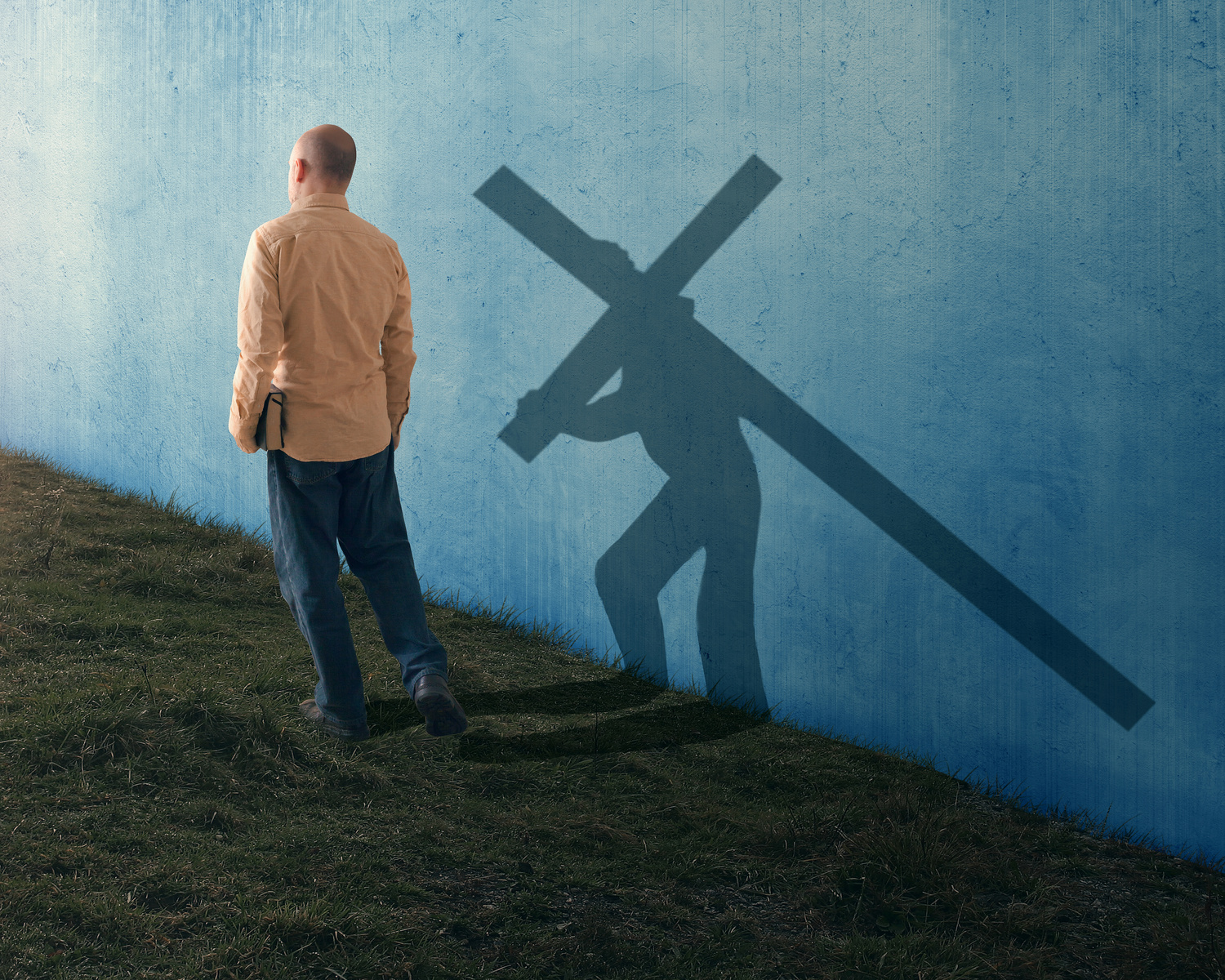 Shadow of man carrying cross